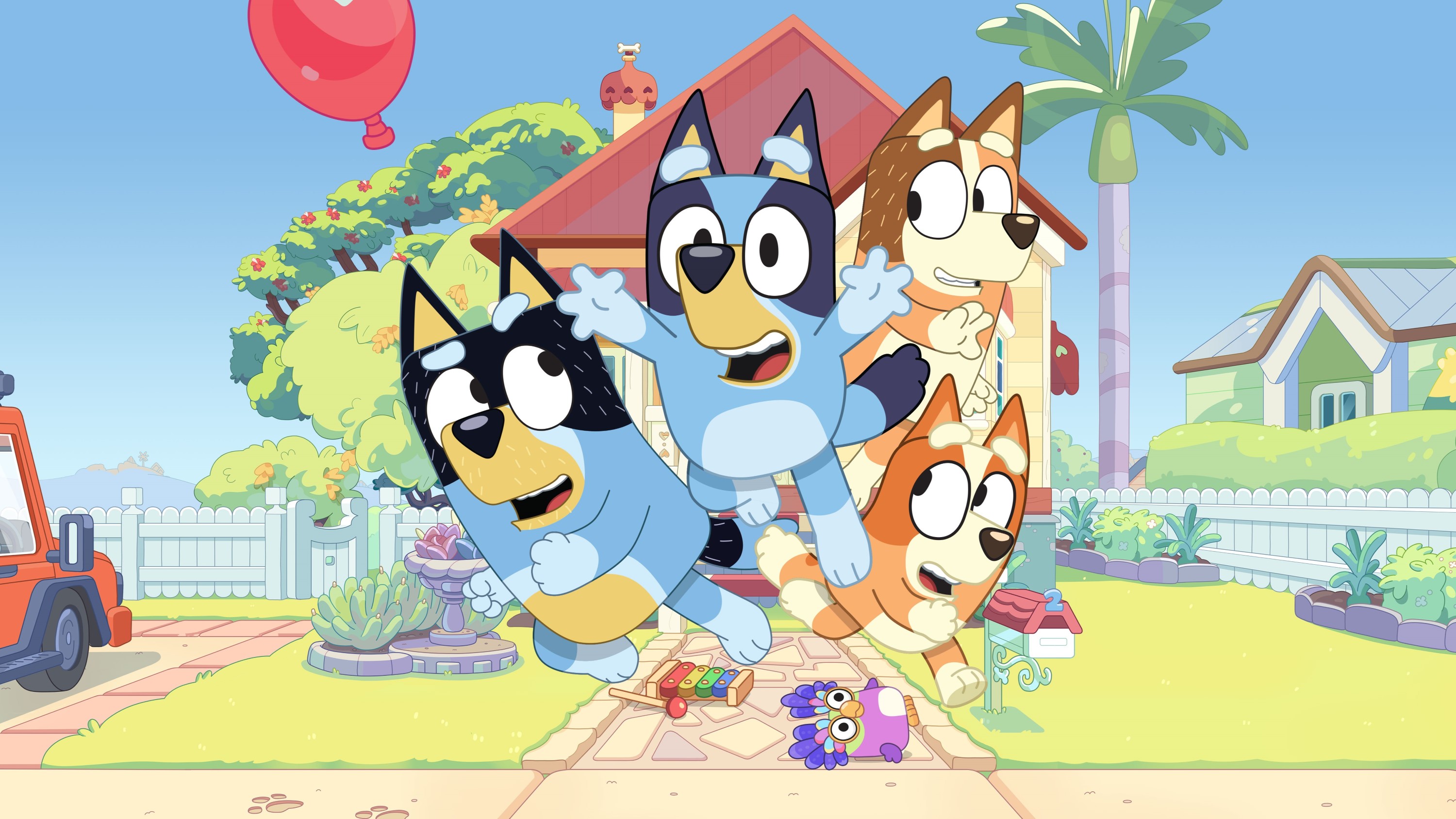 Bluey and her family of cartoon dogs explode out of their pleasant suburban home in key art for Bluey: The Videogame