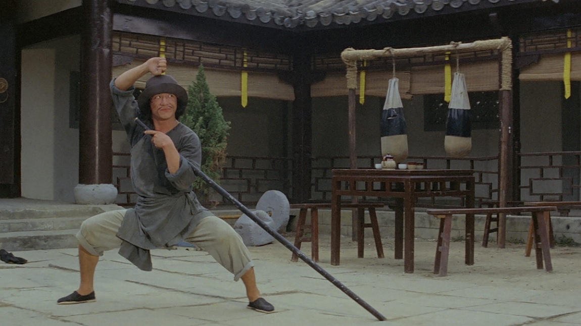 Jackie Chan being his goofy self with a mustache and a pole in The Fearless Hyena
